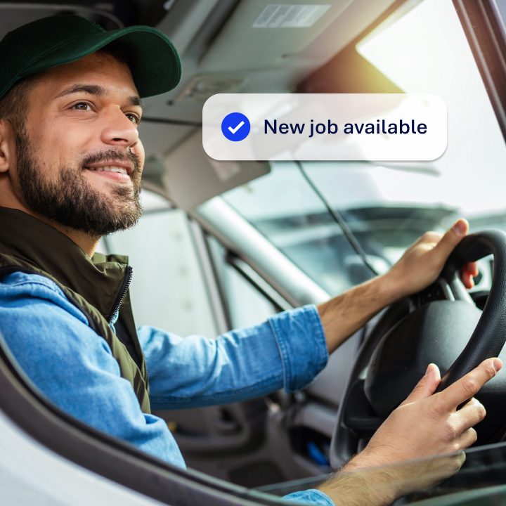 Delivery driver in the drivers seat of a van, looking out of the window. Overlayed on the image is a notification saying 'New job available'